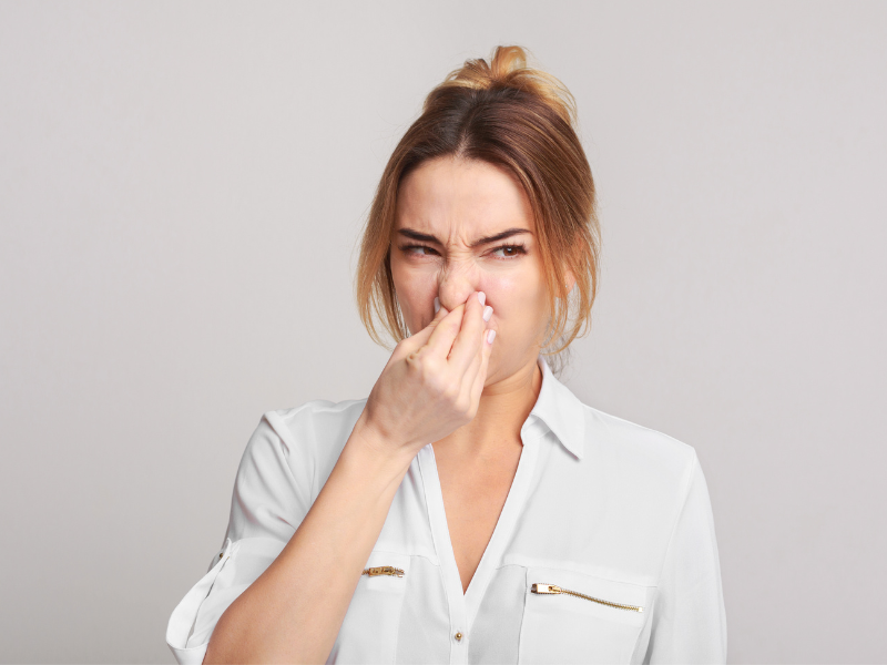 a woman holding her nose