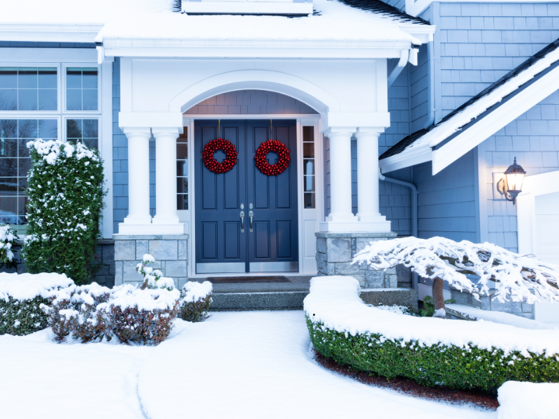 Blue house covered in Snow