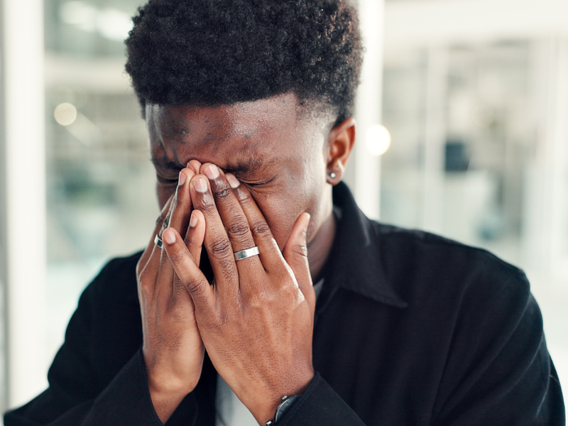 man holding face in hands