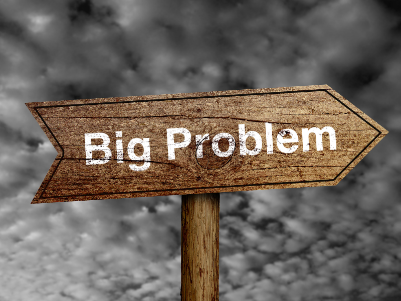 wood sign the says big problem