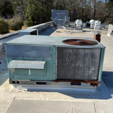 a man adjusting a knob on an air conditioning unit