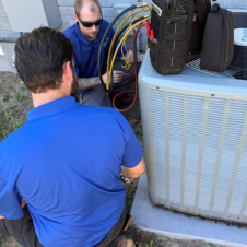 a man using a screwdriver to open a panel
